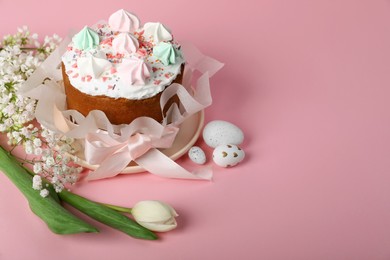 Photo of Traditional Easter cake with meringues and painted eggs on pink background, space for text