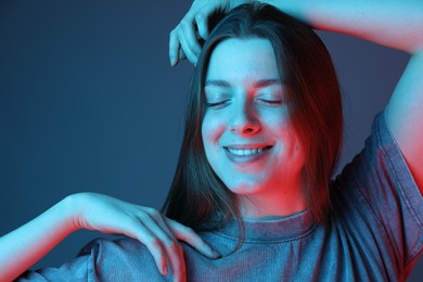 Portrait of beautiful young woman on color background