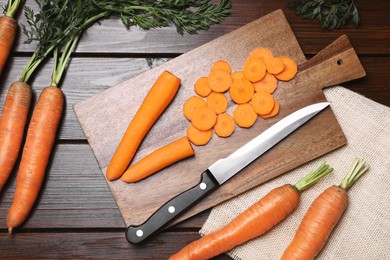 Photo of Tasty fresh carrot on wooden table, flat lay