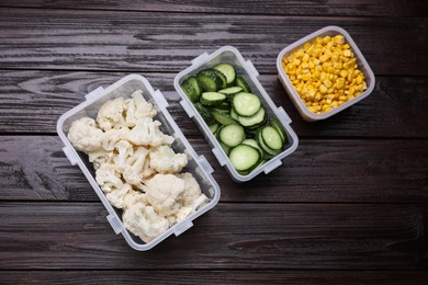 Photo of Plastic containers with different fresh products on wooden table, flat lay