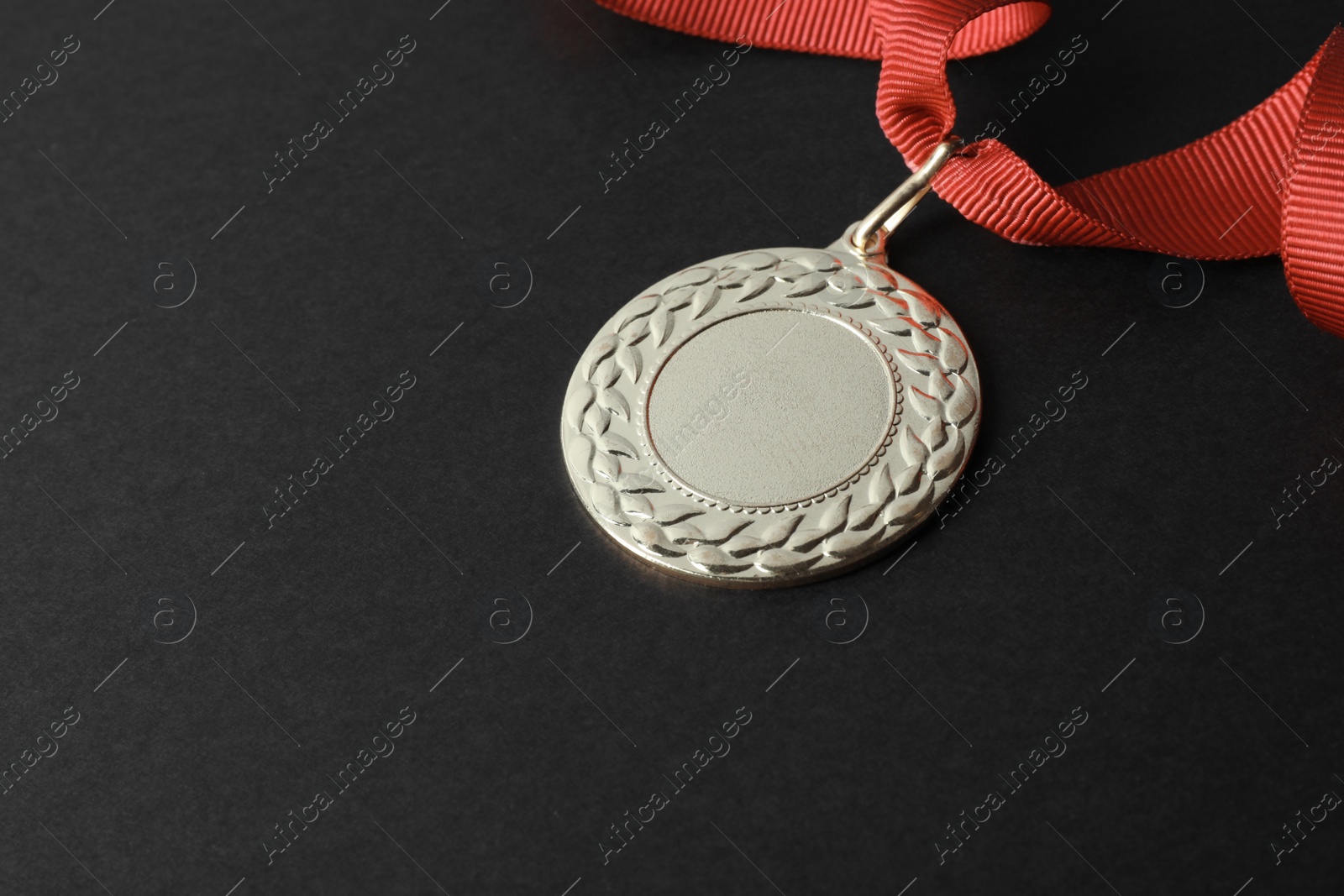 Photo of Gold medal with space for design on black background. Victory concept