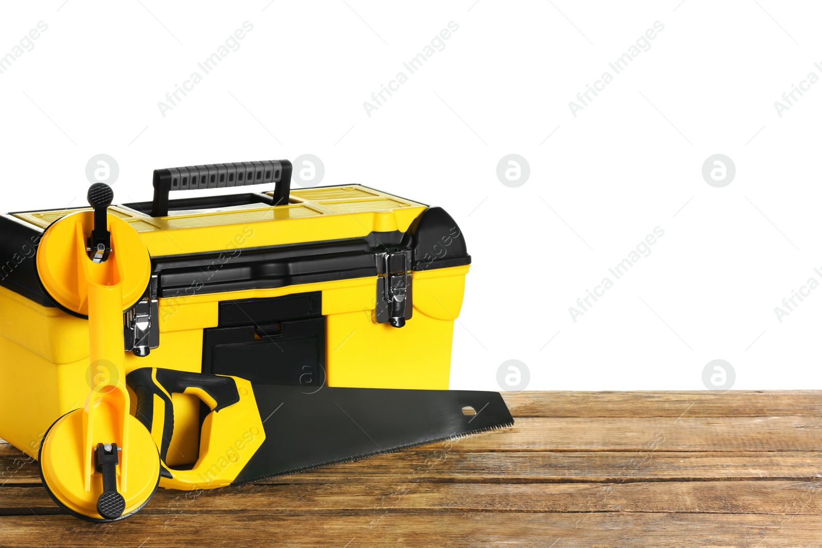 Photo of Plastic box with different tools on wooden table against white background