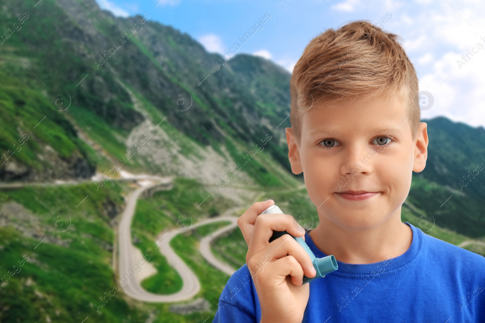 Image of Little boy with asthma inhaler in mountains on sunny day. Emergency first aid during outdoor recreation