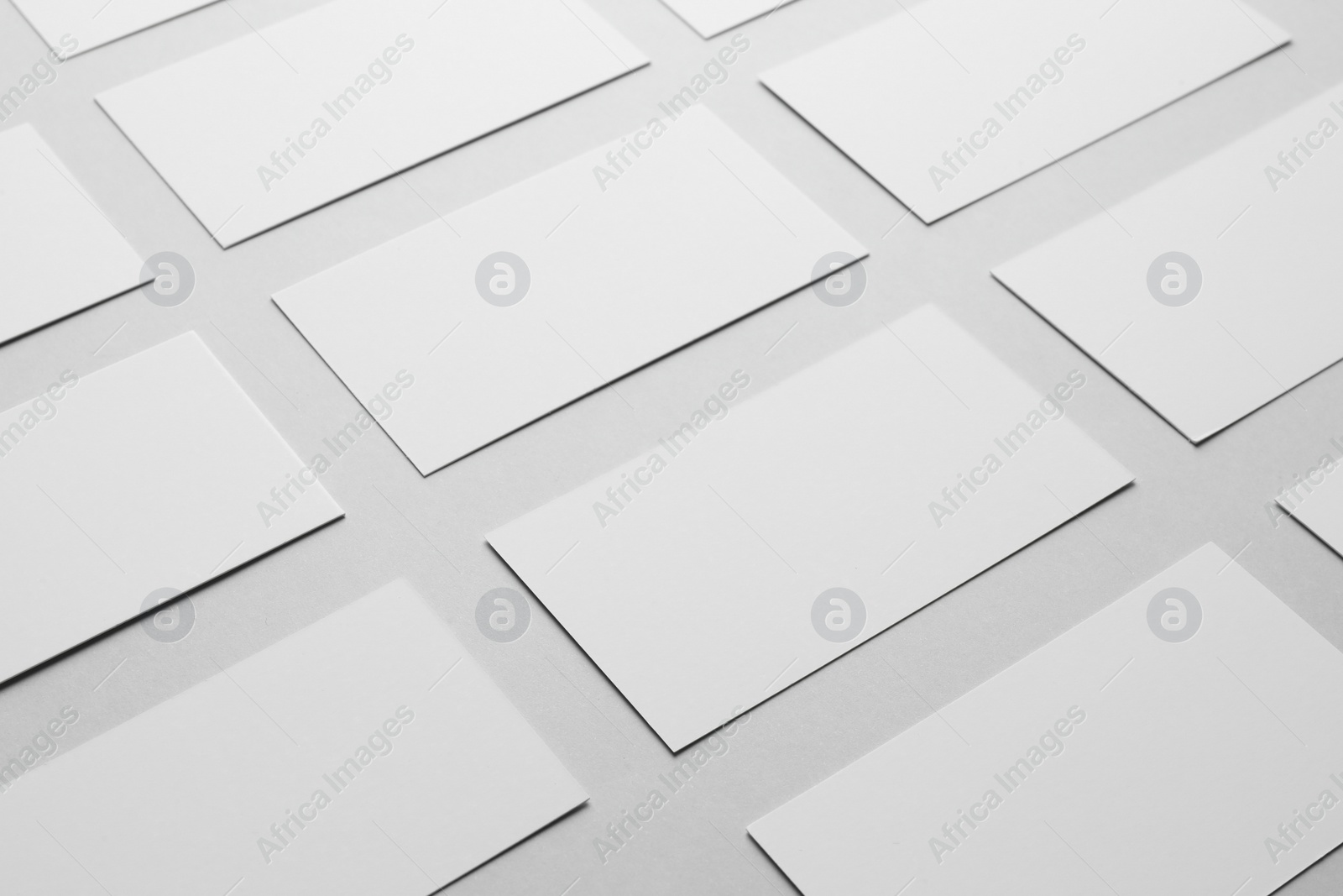 Photo of Blank business cards on light gray background, closeup. Mockup for design