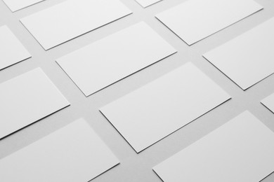 Photo of Blank business cards on light gray background, closeup. Mockup for design