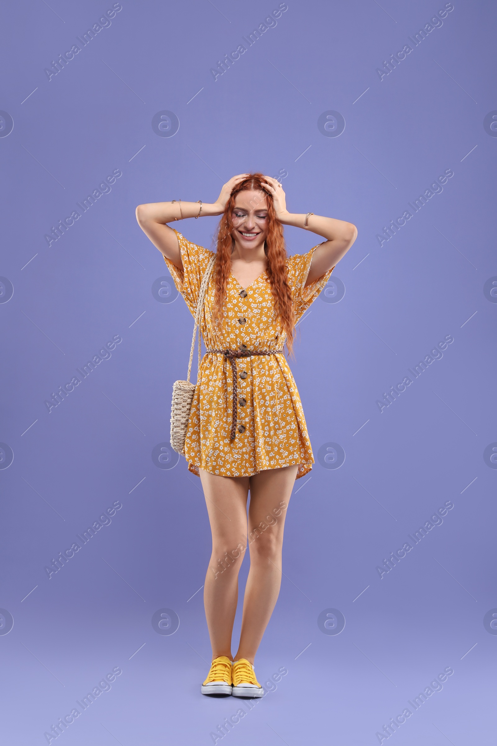 Photo of Stylish young hippie woman on violet background