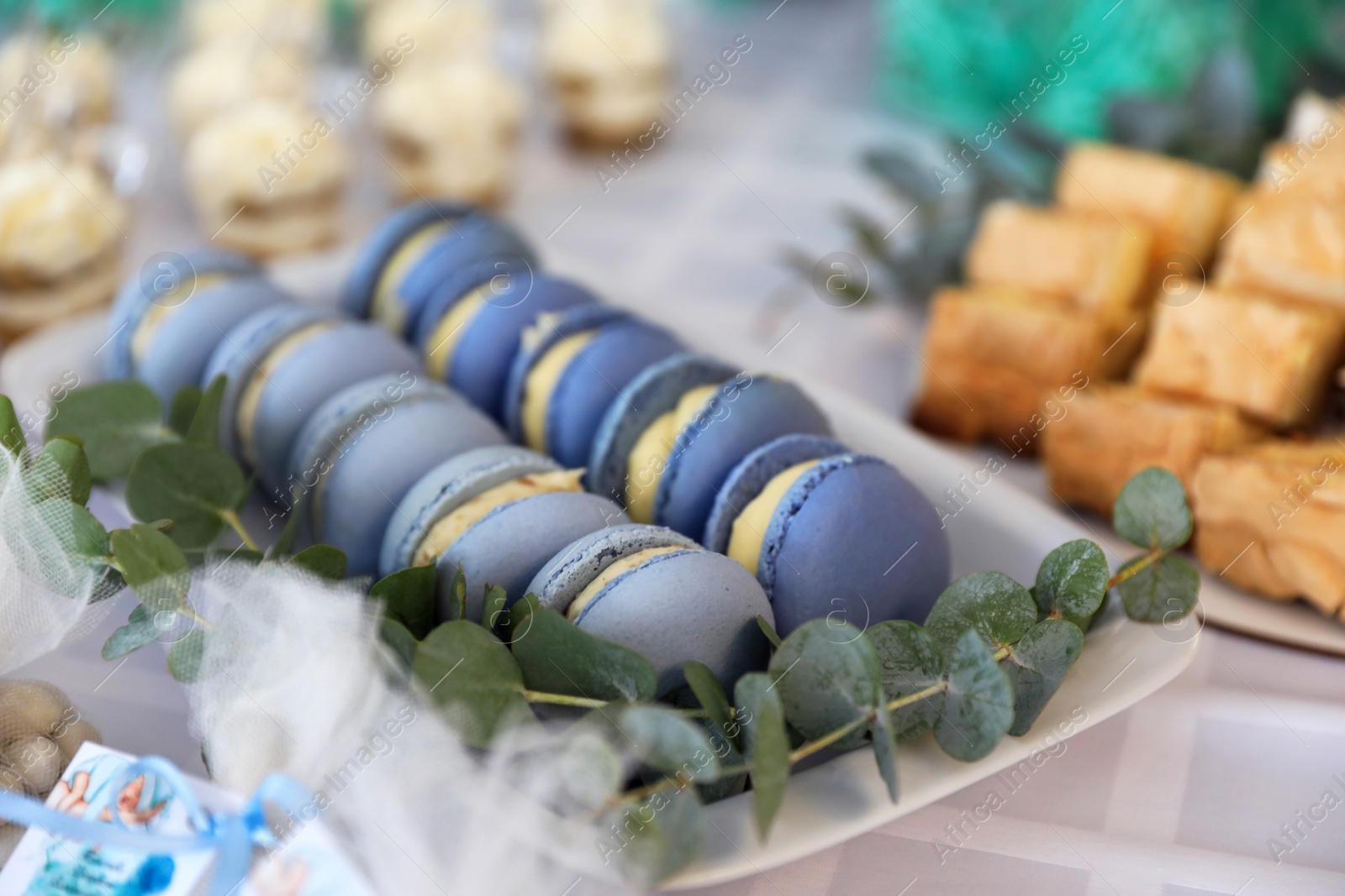 Photo of Delicious sweet macarons served on table, closeup