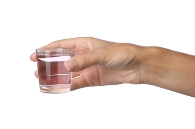 Woman holding glass with mouthwash for teeth care on white background