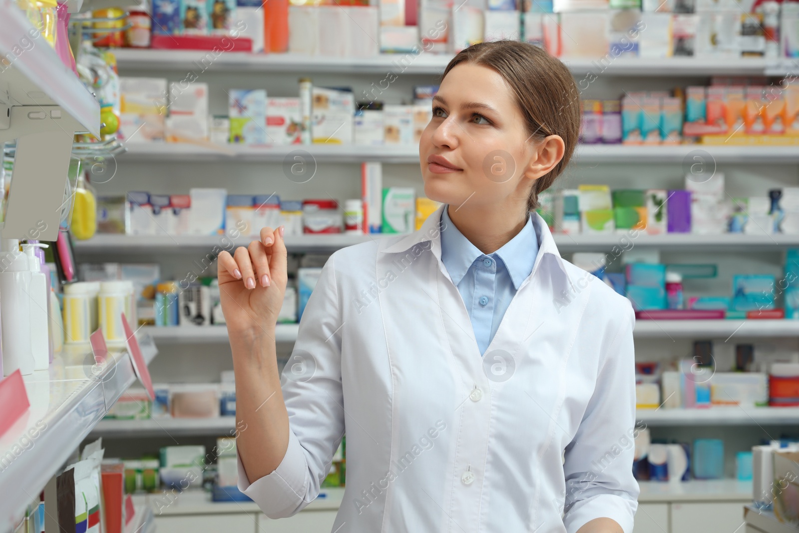 Image of Professional pharmacist near shelves in modern drugstore