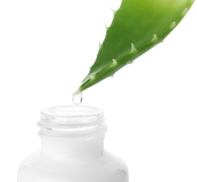 Aloe juice dripping from leaf into bottle on white background