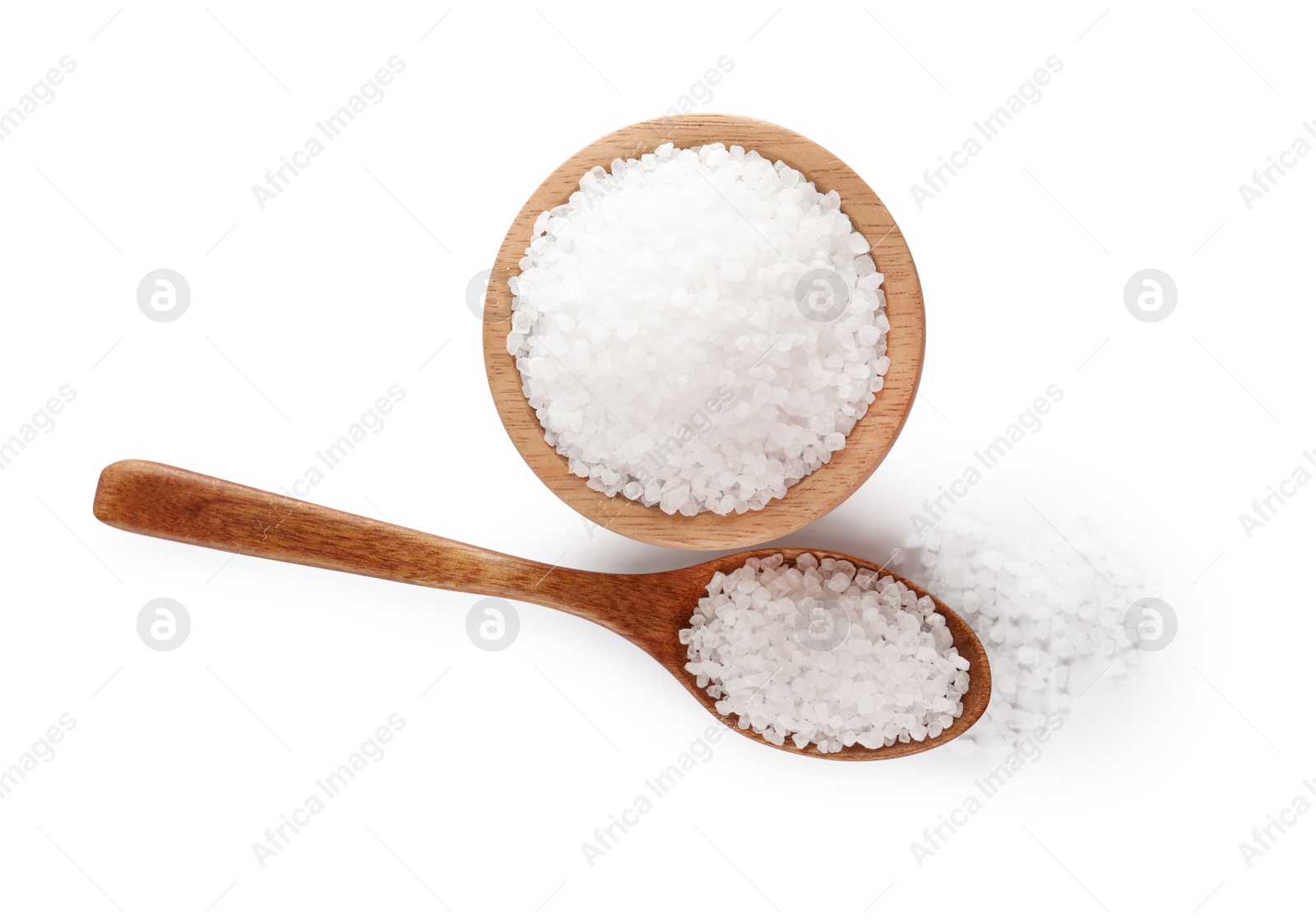 Photo of Wooden bowl and spoon with natural sea salt isolated on white, top view