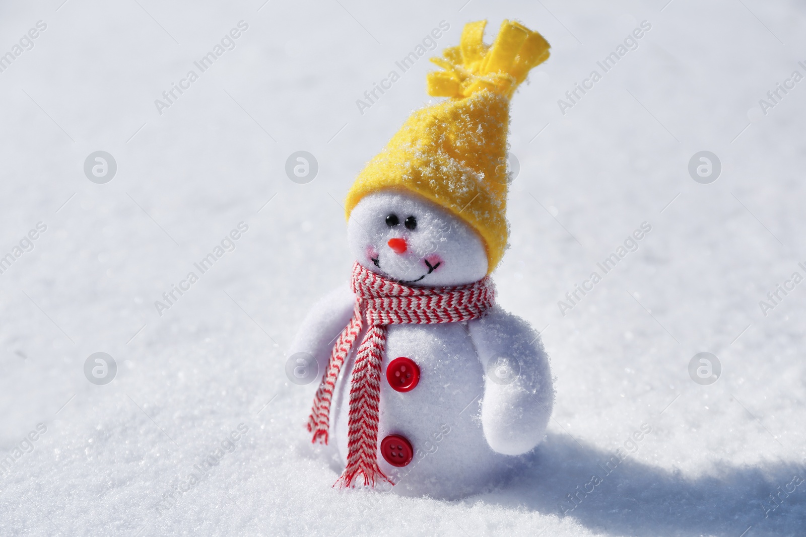 Photo of Cute small decorative snowman on snow outdoors