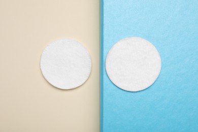 Clean cotton pads on color background, flat lay