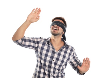 Young man with black blindfold on white background