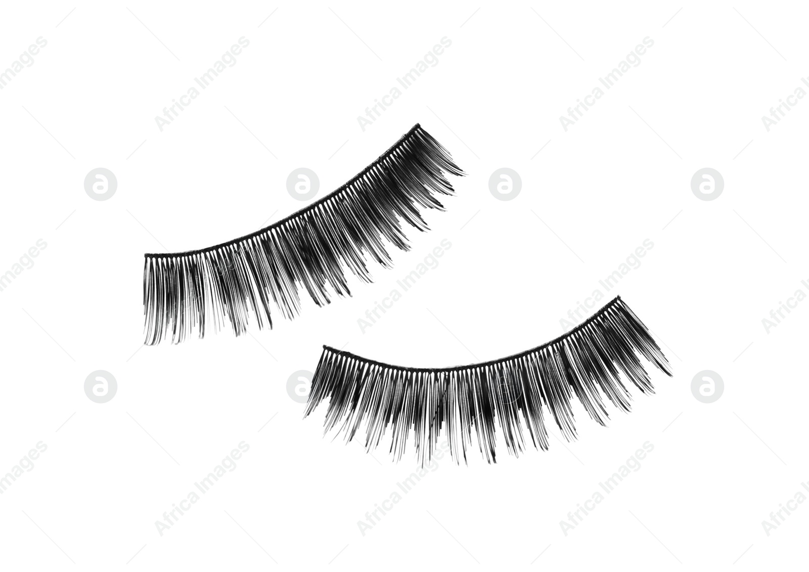 Photo of Fake eyelashes on white background, top view. Makeup product