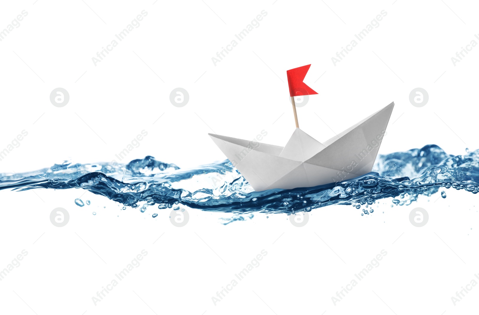 Image of Handmade paper boat floating on clear water against white background 