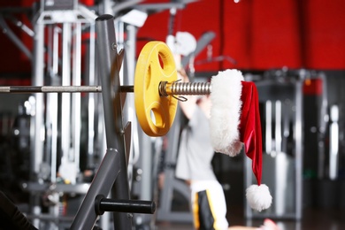 Santa Claus hat on barbell in gym