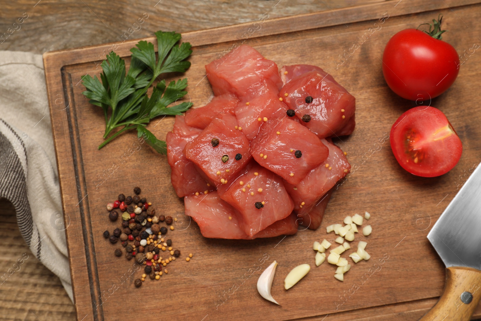 Photo of Raw beef meat and different ingredients for cooking delicious goulash on wooden table, flat lay