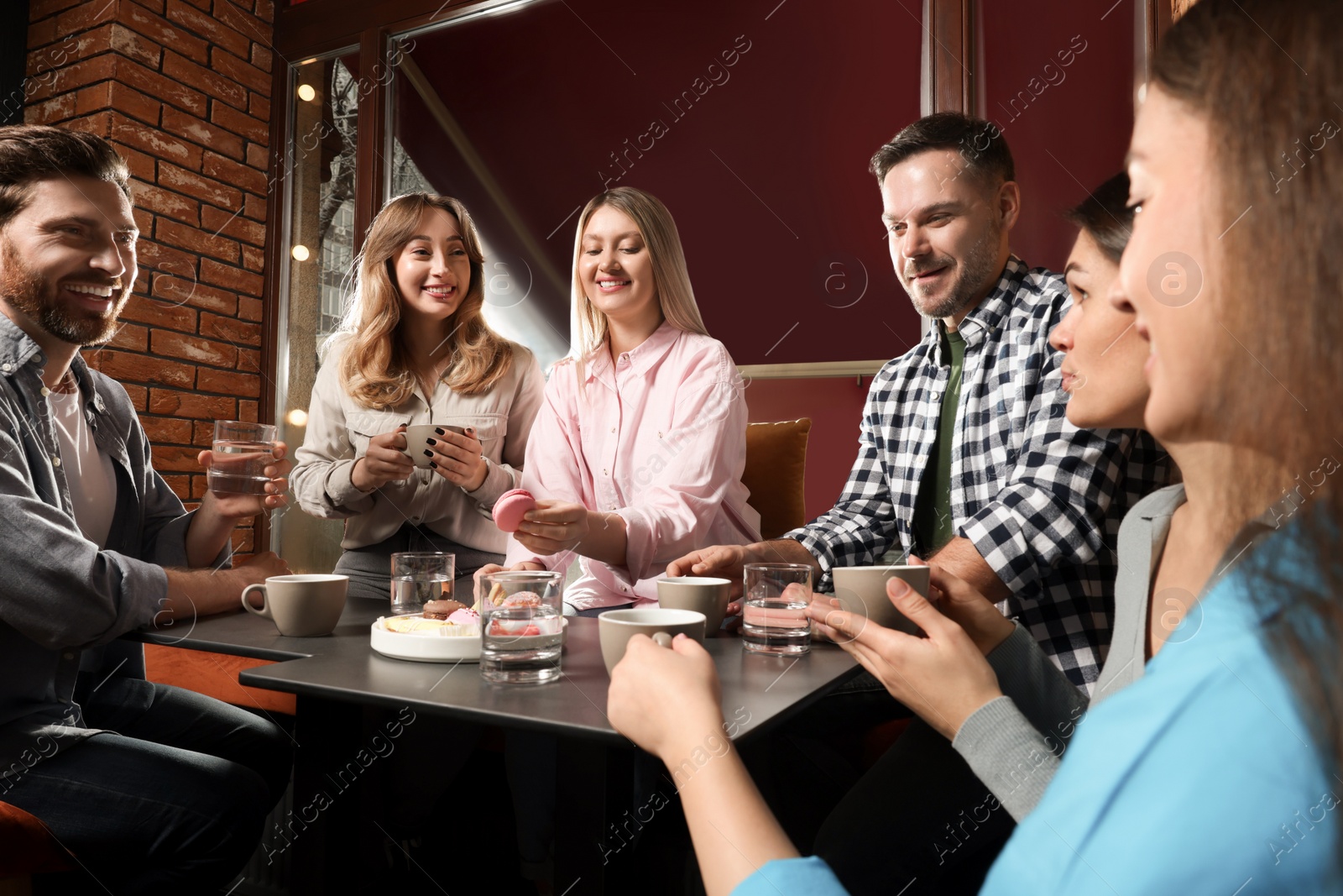 Photo of Friends with coffee spending time together in cafe