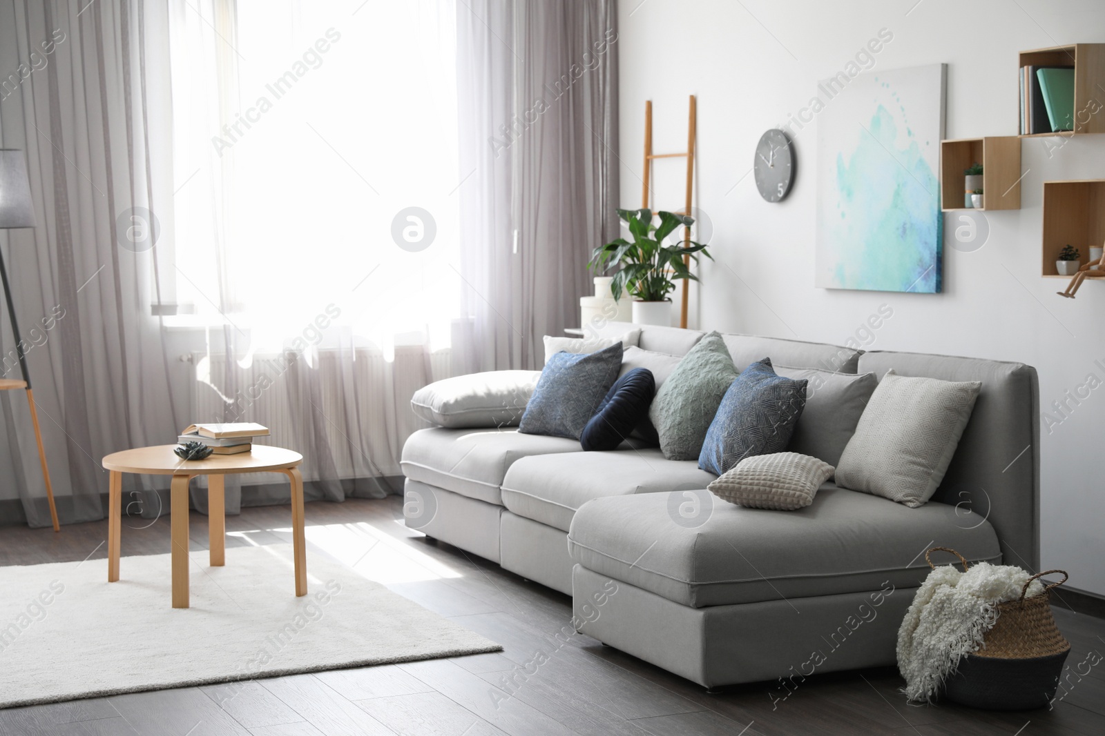 Photo of Elegant living room with comfortable sofa near window. Interior design