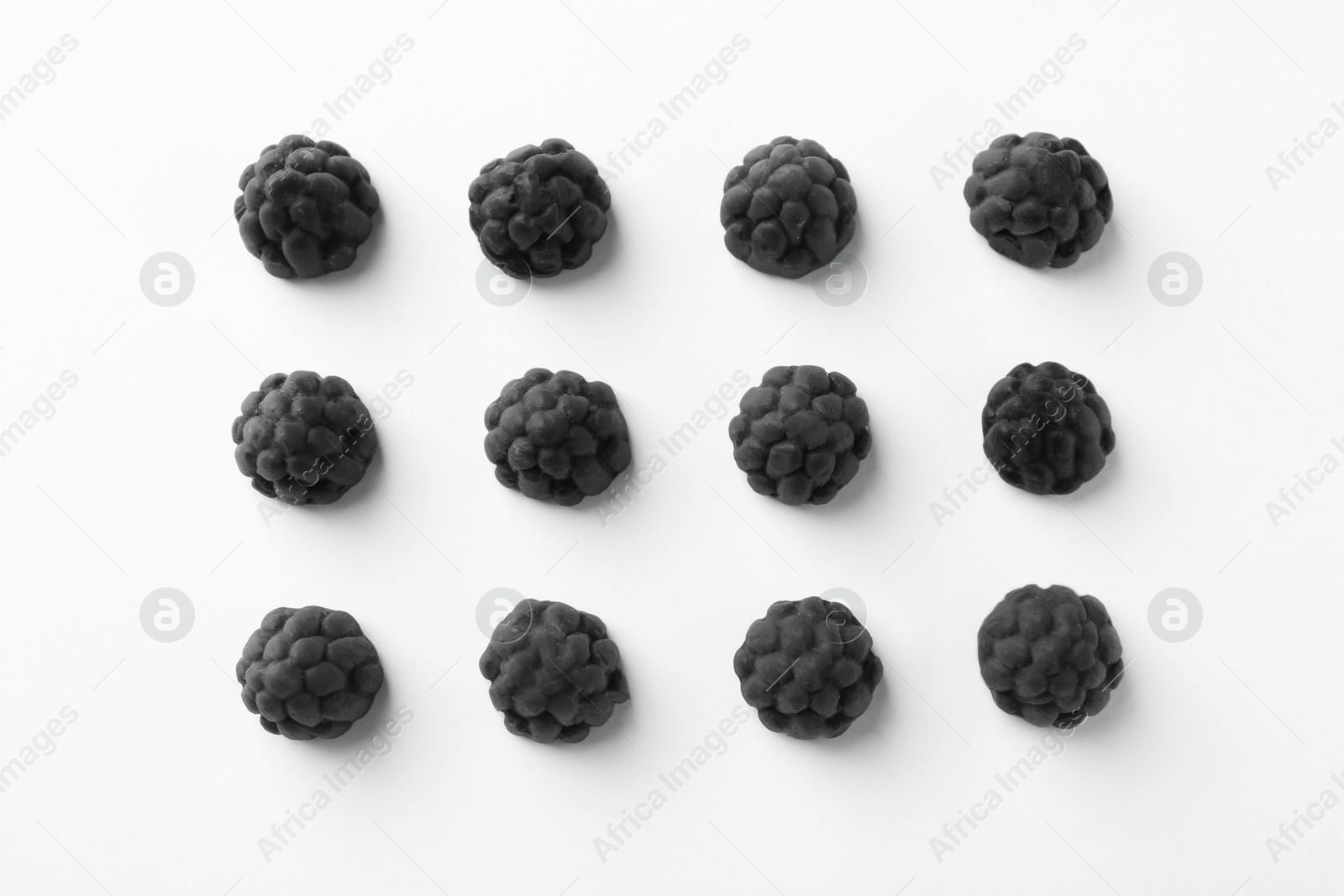 Photo of Tasty liquorice candies on light background, flat lay