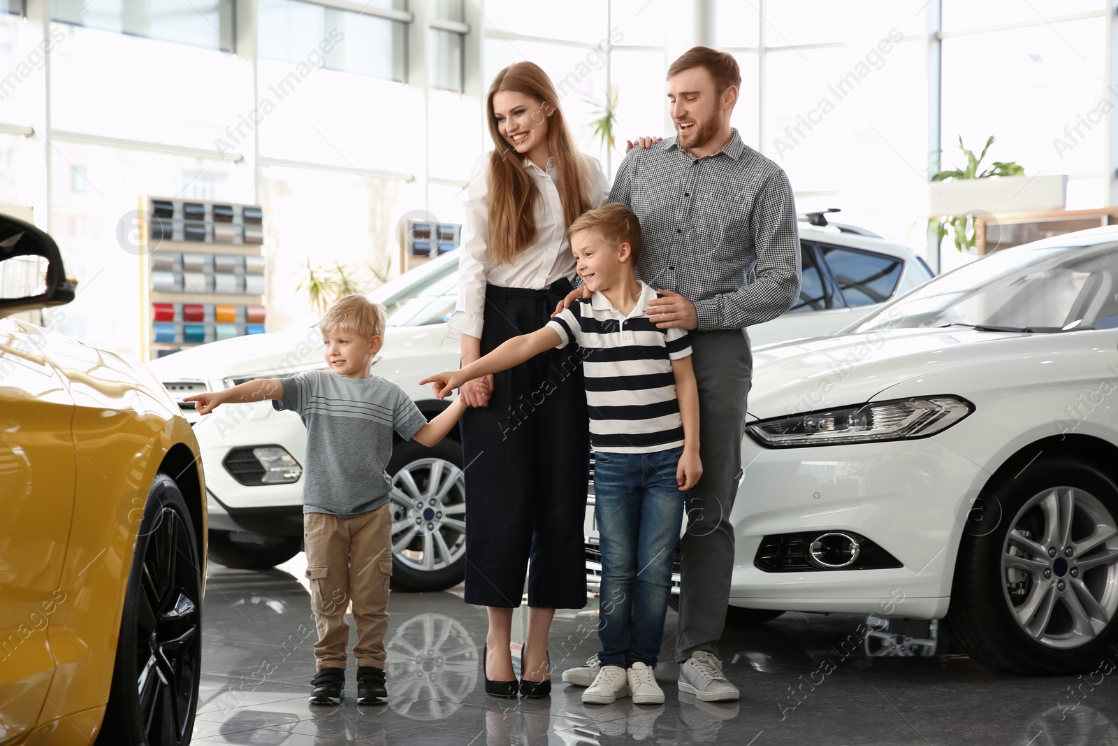 Photo of Young family in car salon