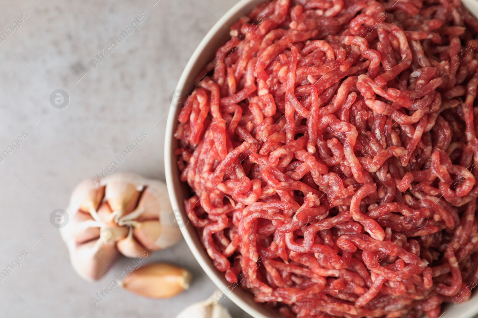 Photo of Fresh raw minced meat on light table, closeup