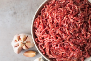 Fresh raw minced meat on light table, closeup