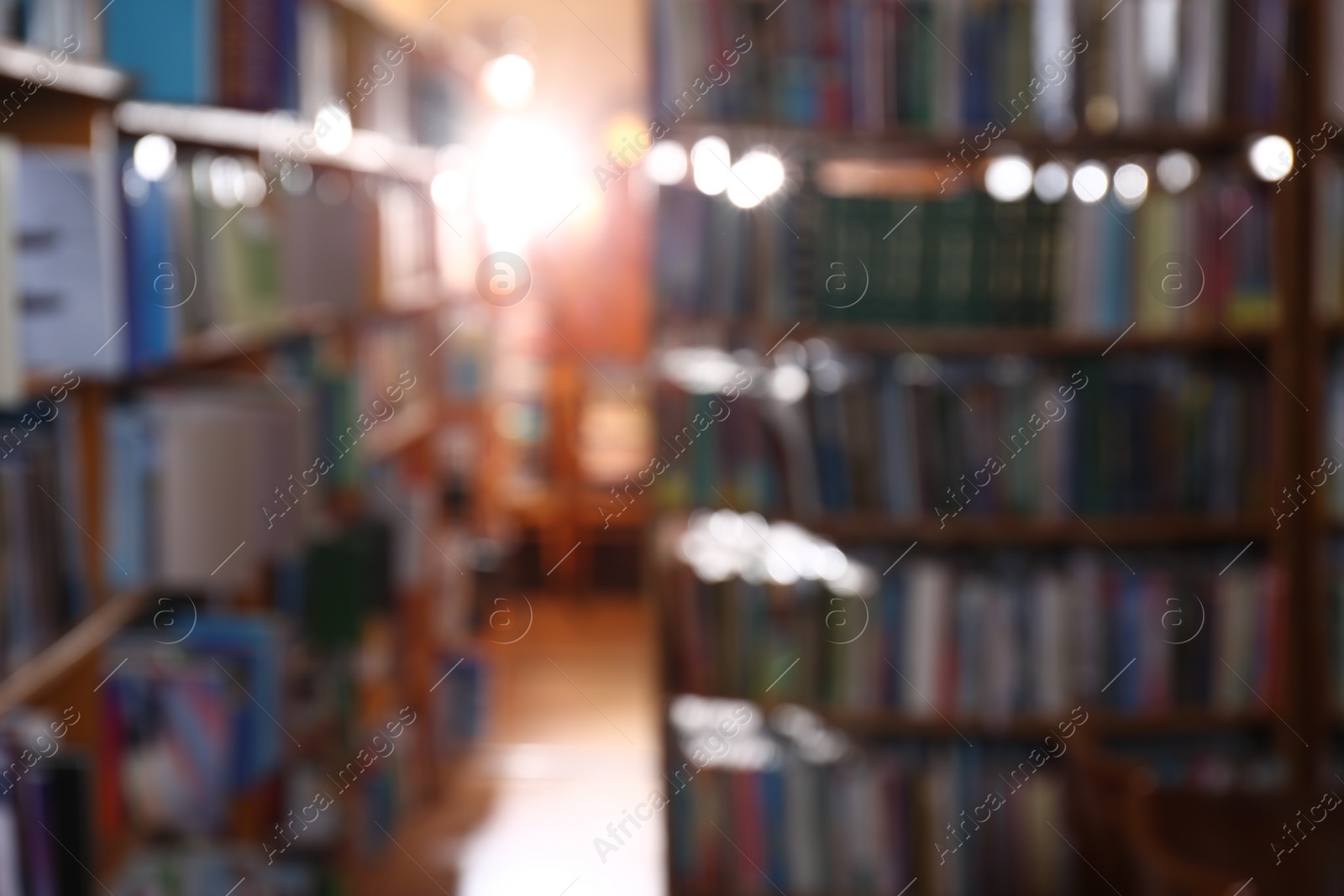 Photo of Blurred view of different books on shelves in library