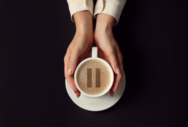 Coffee Break. Woman with cup of americano on black background, top view