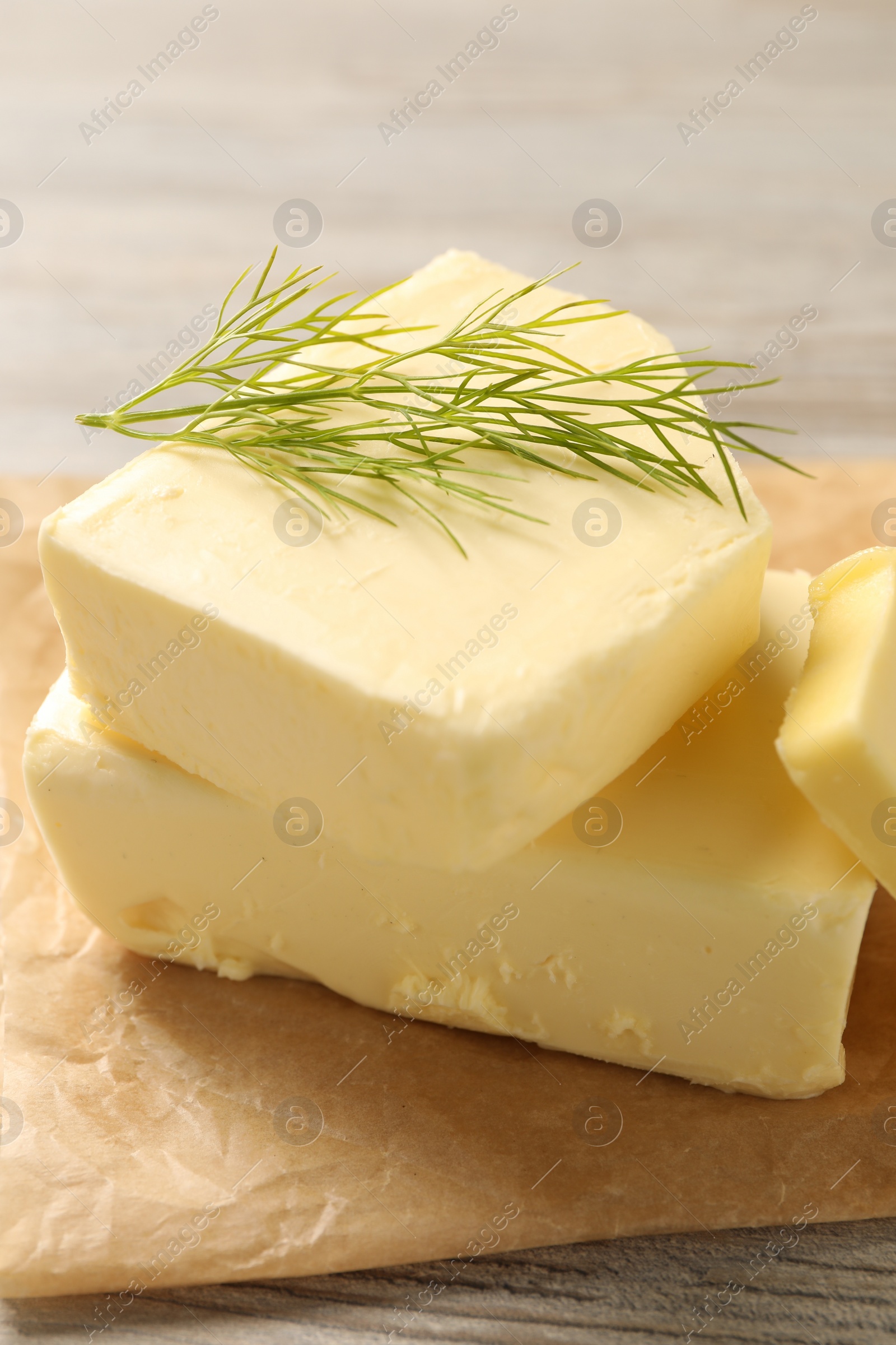 Photo of Tasty butter with dill on wooden table, closeup