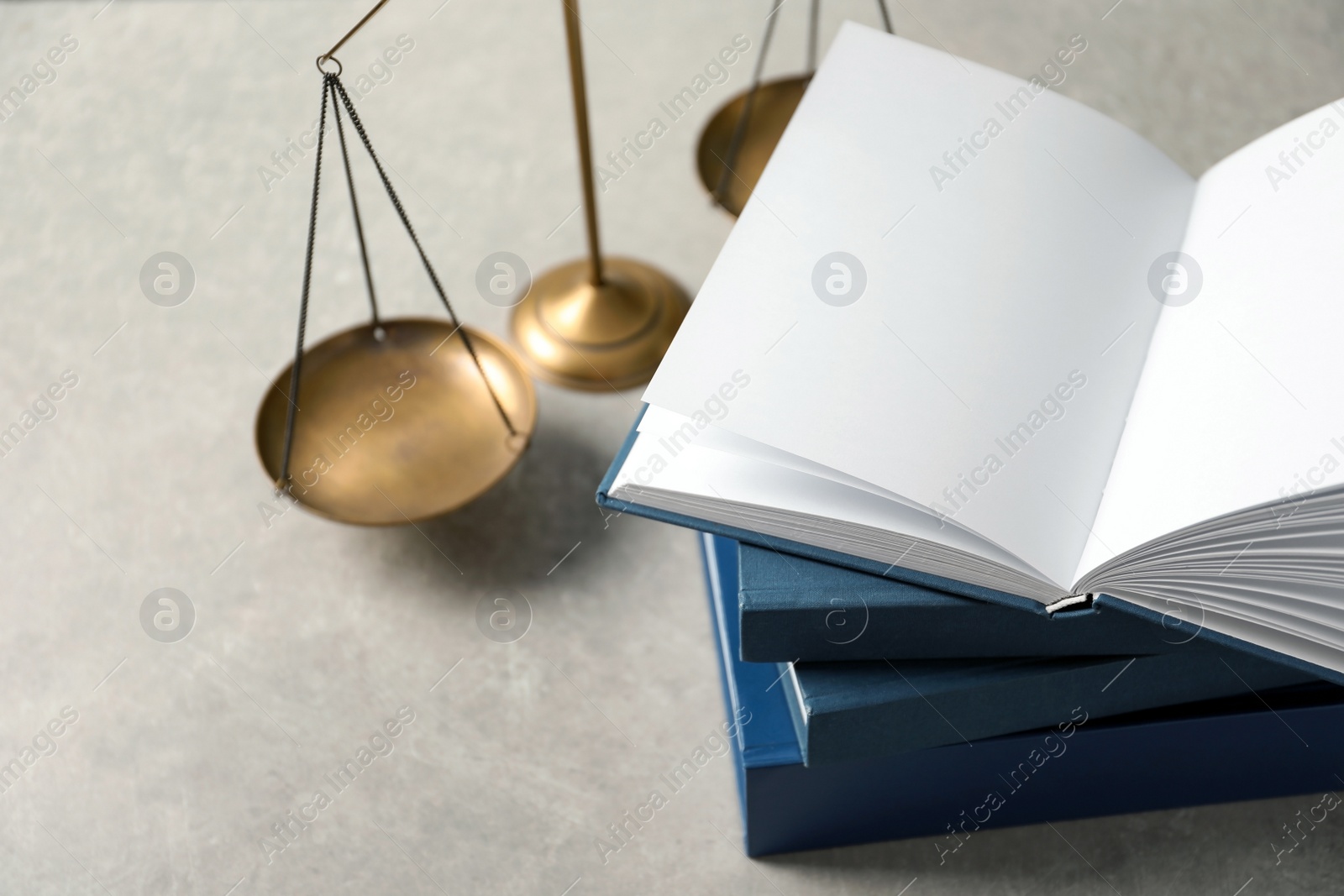 Photo of Scales of justice and books on table. Law concept