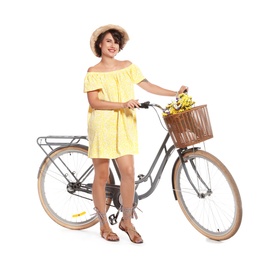 Portrait of beautiful young woman with bicycle on white background