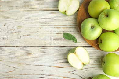 Photo of Flat lay composition of fresh ripe green apples on white wooden table, space for text