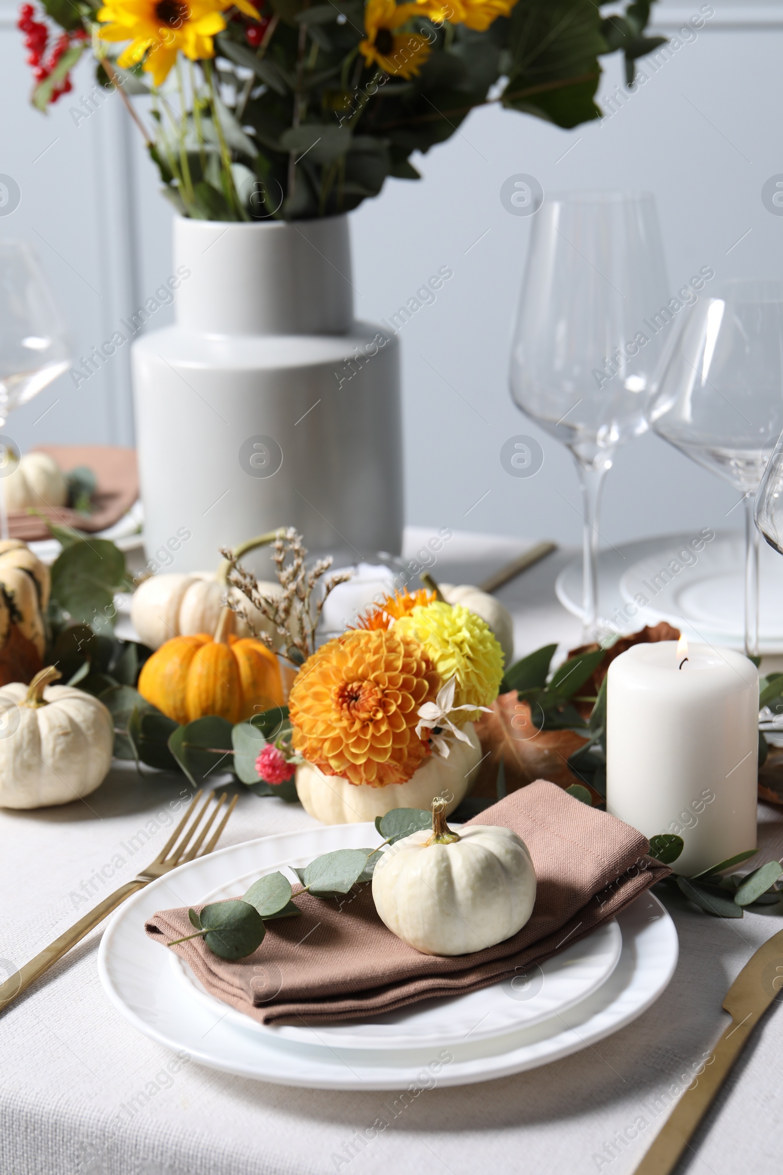 Photo of Beautiful autumn table setting. Plates, cutlery, glasses and floral decor