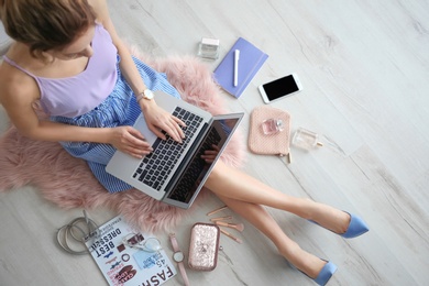 Female beauty blogger with laptop indoors, top view