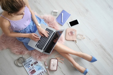 Photo of Female beauty blogger with laptop indoors, top view