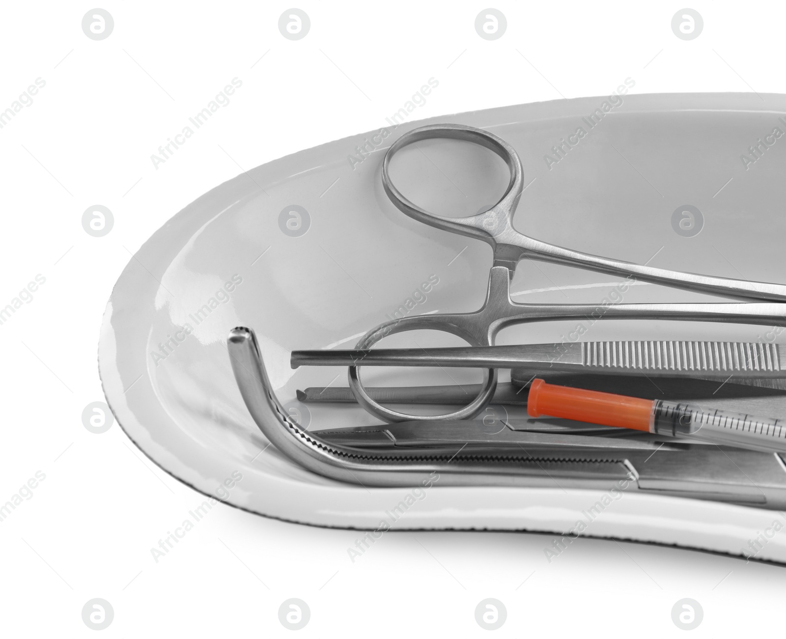 Photo of Surgical instruments in kidney dish on white background