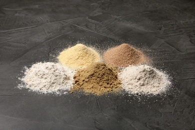 Photo of Piles of different flour types on grey table