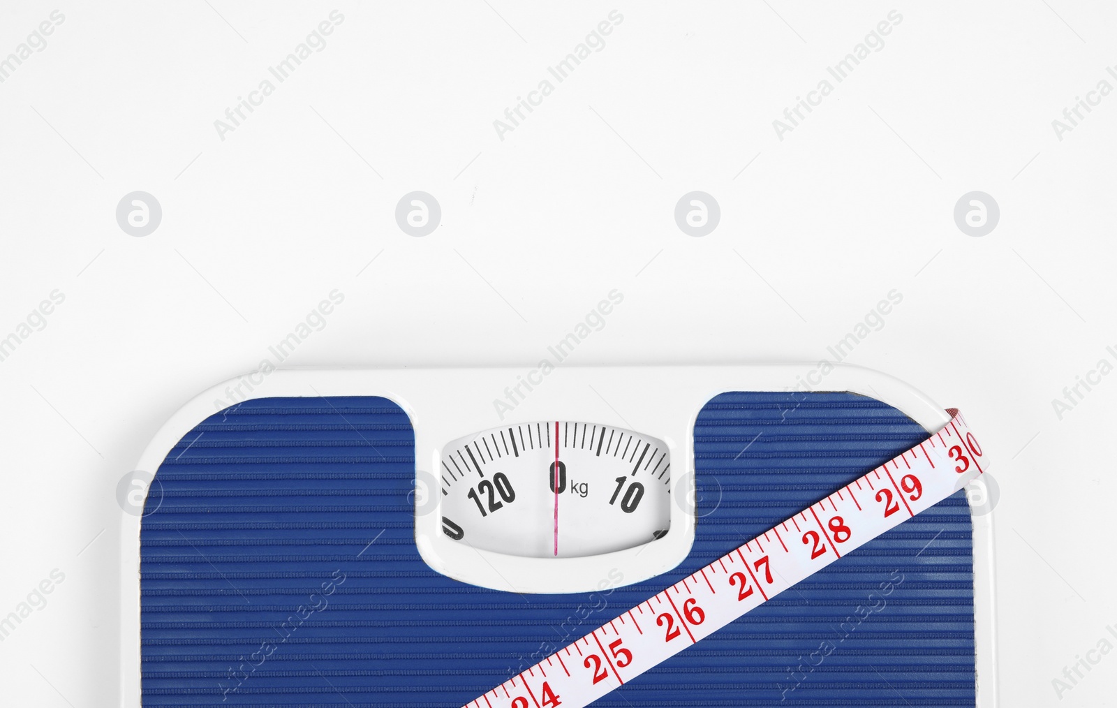 Photo of Modern scales and tape measure isolated on white, top view