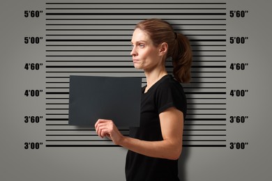 Criminal mugshot. Arrested woman with blank card against height chart