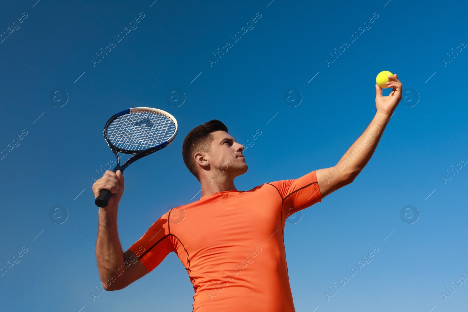 Photo of Man playing tennis at court on sunny day