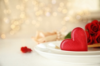 Photo of Romantic table setting against blurred lights, space for text. Valentine's day celebration