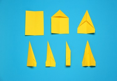 Photo of Making paper plane step by step. Instruction on light blue background, flat lay
