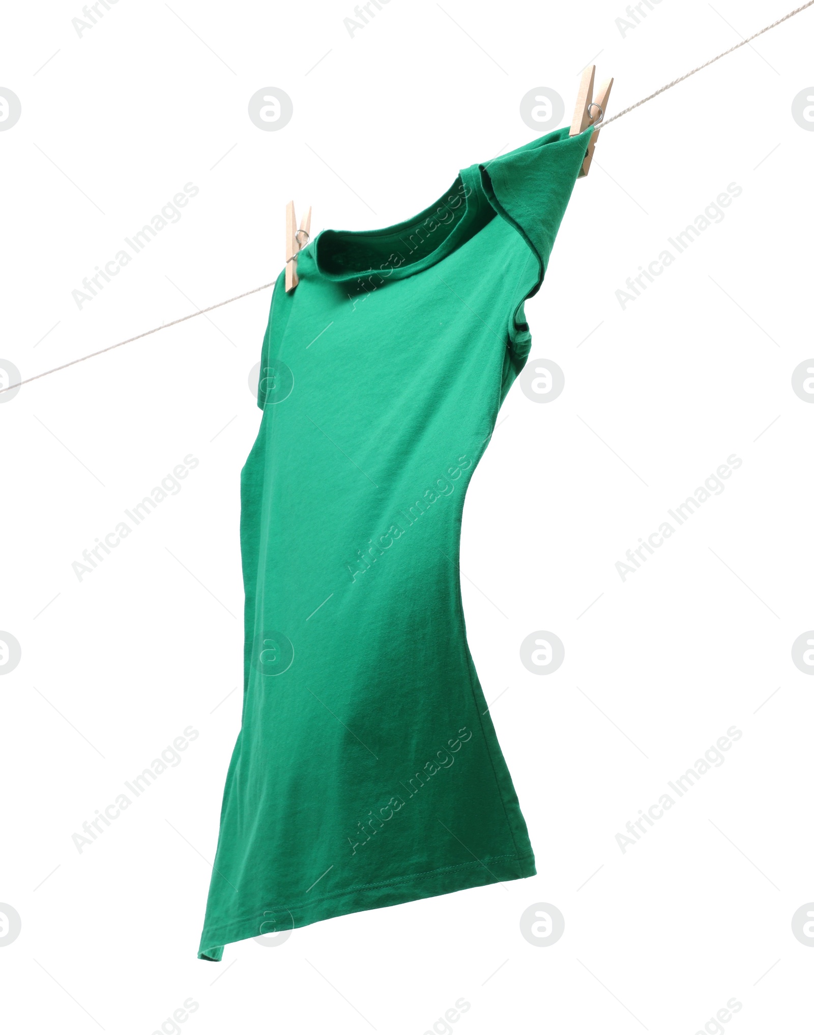 Photo of One green t-shirt drying on washing line isolated on white