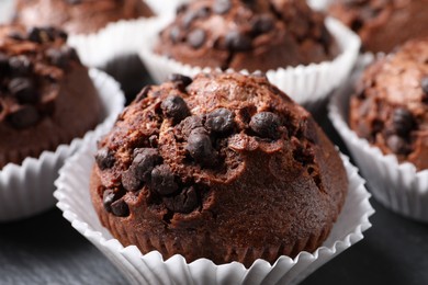 Photo of Tasty chocolate muffins on black table, closeup