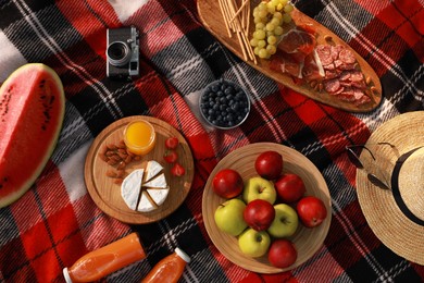 Photo of Delicious food, drinks and camera on plaid, flat lay. Summer picnic