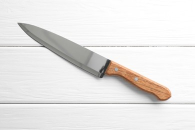 Photo of One sharp knife on white wooden table, top view