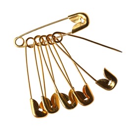 Photo of New golden safety pins on white background