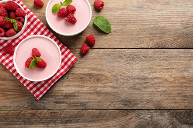 Photo of Delicious raspberry mousse with mint on wooden table, flat lay. Space for text